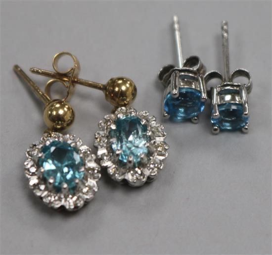 A pair of 9ct gold, blue zircon and diamond cluster earrings and a pair of white metal single stone earrings.